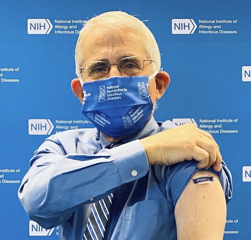 In this September 2020 photo provided by the National Foundation for Infectious Diseases, Anthony Fauci, director of the National Institute of Allergy and Infectious Diseases, National Institutes of Health, shows a bandage on his arm after receiving an influenza vaccine to kick-off the 2020-2021 flu season with the NFID in Bethesda, Md. (NFID via AP)