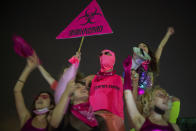 Protesters chant slogans and hold banners against Israeli Prime Minister Benjamin Netanyahu and the new coronavirus countrywide lockdown in Tel Aviv, Israel, Thursday, Sept. 17, 2020. Netanyahu's government has imposed a three-week lockdown, beginning on Friday afternoon. (AP Photo/Ariel Schalit)