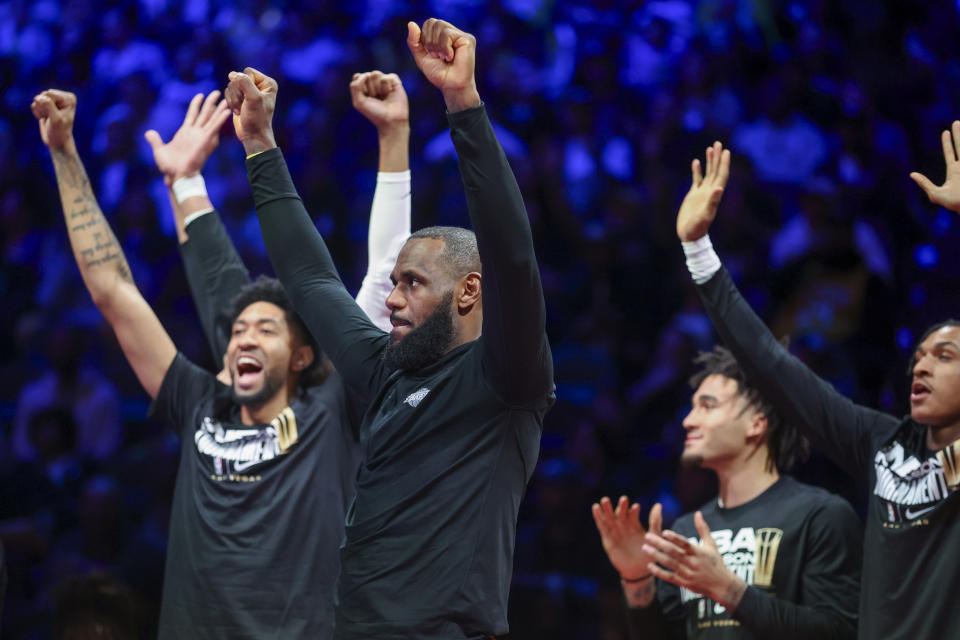 Los Angeles Lakers forward LeBron James, second from left, celebrates from the bench with teammates after a play against the New Orleans Pelicans during the second half of a semifinal in the NBA basketball In-Season Tournament, Thursday, Dec. 7, 2023, in Las Vegas. (AP Photo/Ian Maule)