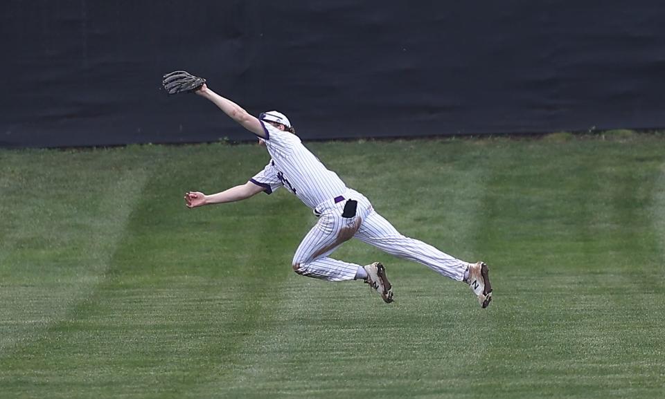 CHCA's  Jack Vogele (12) makes a diving catch during their baseball game against Cincinnati Country Day Tuesday, April 12, 2022.