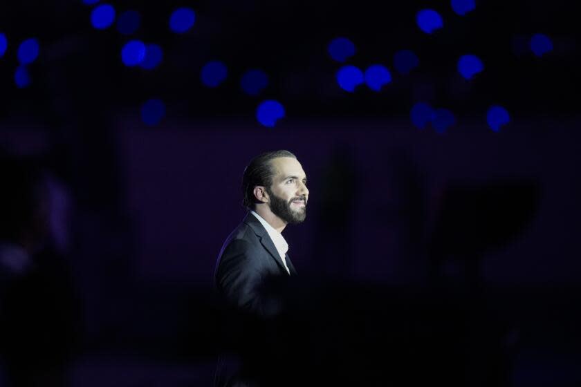 FILE - Salvadoran President Nayib Bukele is illuminated by a stage spotlight during the Central American and Caribbean Games opening ceremony, at the newly remodeled Jorge "El Magico" Gonzalez stadium in San Salvador, El Salvador, June 23, 2023. Bukele was officially nominated by his New Ideas party Sunday, July 9, to run for reelection next year, brushing aside objections from legal experts and opposition figures who say El Salvador's constitution prohibits his candidacy. (AP Photo/Arnulfo Franco, File)