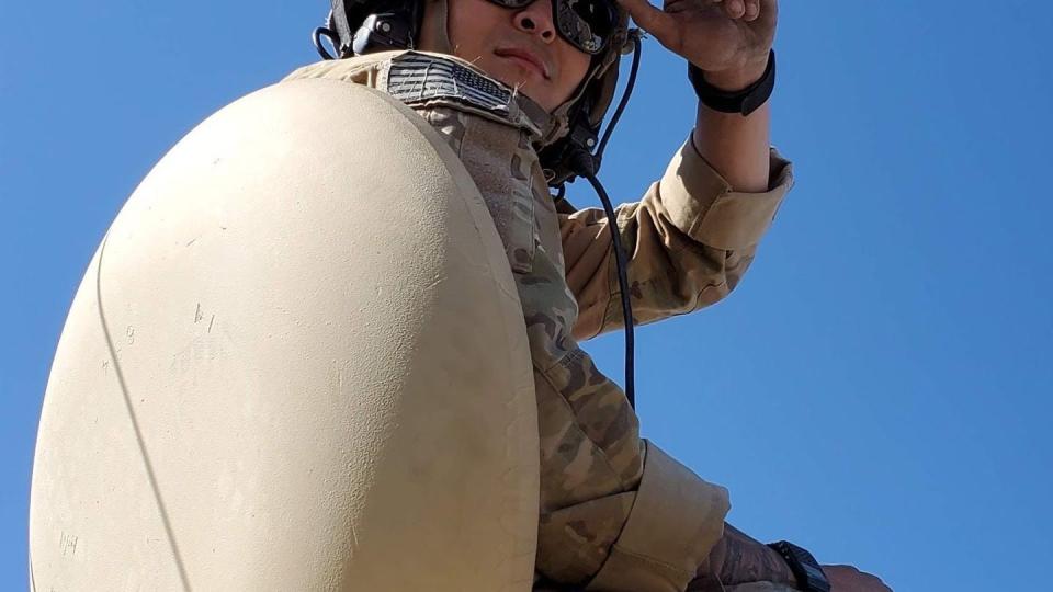 Sgt. Bayaman Michael Barcus rides atop an M113 personnel carrier during 1st Battalion, 66th Armor Regiment's May 2021 training rotation at the National Training Center, Fort Irwin, California. (Sgt. Collin Pattan/Army)