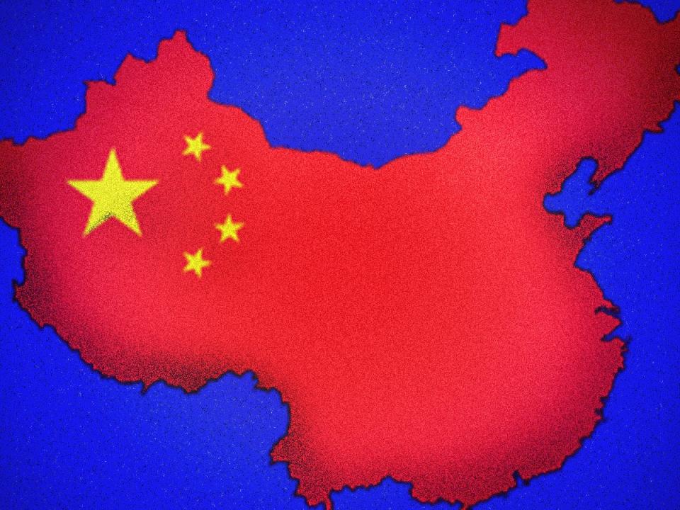 Flag map of China shrinking on blue grainy background