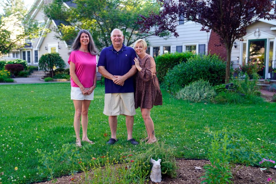 From left: Michele Cohen, Shawn Emery and his wife Debbie Emery in Cohen's front yard in Glen Rock, where she found Shawn's wedding ring 28 years after it went missing.