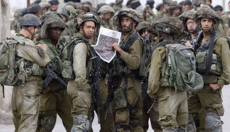 Israeli soldiers take part in an operation to locate three Israeli teens near the West Bank city of Hebron June 21, 2014. REUTERS/Mussa Qawasma