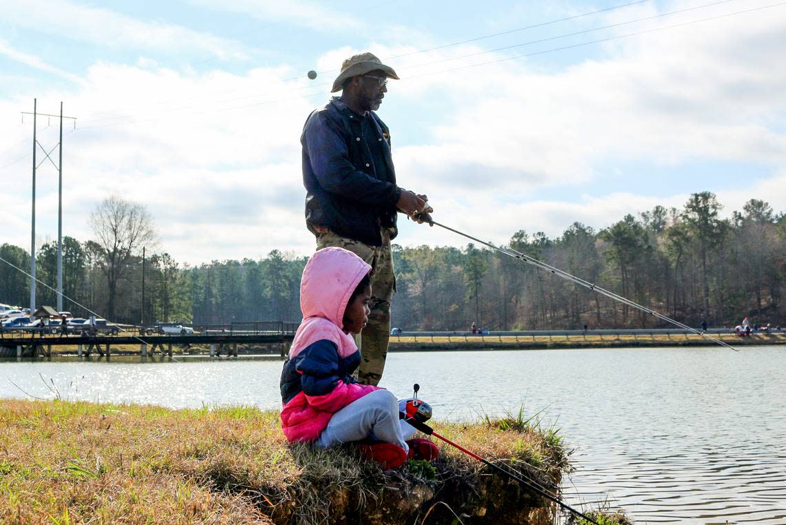 Kobi Cross and her uncle Willie Mobley fish during the annual Kids Fishing Derby Saturday at Javors Lucas Lake.