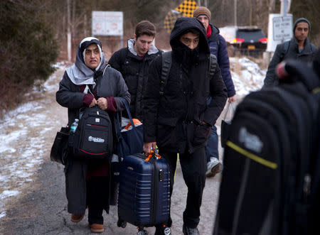 A group that claimed to be from Turkey crosses the U.S.-Canada border illegally leading into Hemmingford, Quebec, Canada March 6, 2017. REUTERS/Christinne Muschi