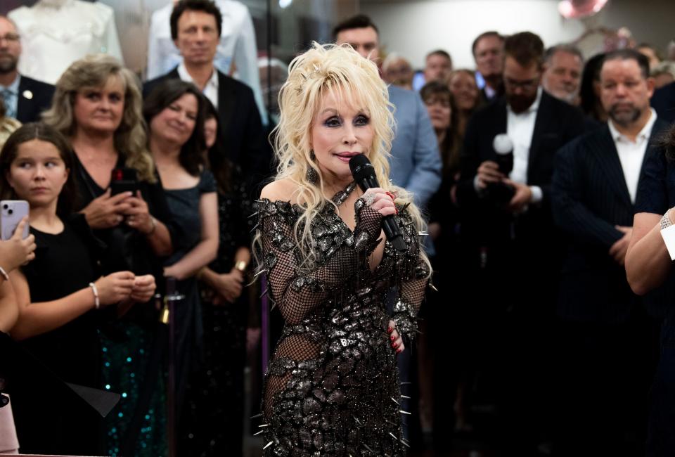 Dolly Parton speaks to the crowd at the opening of the Dolly Parton & The Makers: My Life In Rhinestones fashion exhibition at Lipscomb University in Nashville, Tenn., Friday, Oct. 27, 2023.