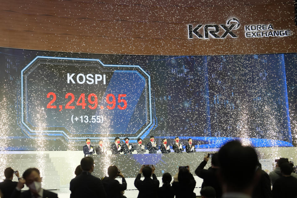 A huge screen shows the Korea Composite Stock Price Index (KOSPI) as participants applaud during the opening ceremony of the 2023 trading year at the Korea Exchange in Seoul, South Korea, Monday, Jan. 2, 2023. (AP Photo/Lee Jin-man)