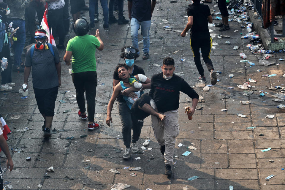 An injured protester is rushed to a hospital during anti-government demonstrations in Baghdad, Iraq, Tuesday, Oct. 29, 2019. (AP Photo/Khalid Mohammed)
