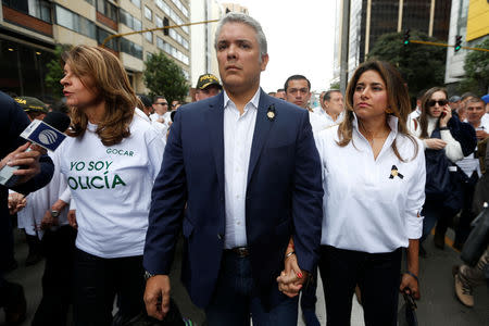 Colombia's President Ivan Duque walks next to with his wife, Maria Juliana Ruiz and the Colombian Vice President, Marta Lucia Ramirez during a rally against violence, following a car bomb explosion, in Bogota, Colombia January 20, 2019. REUTERS/Luisa Gonzalez