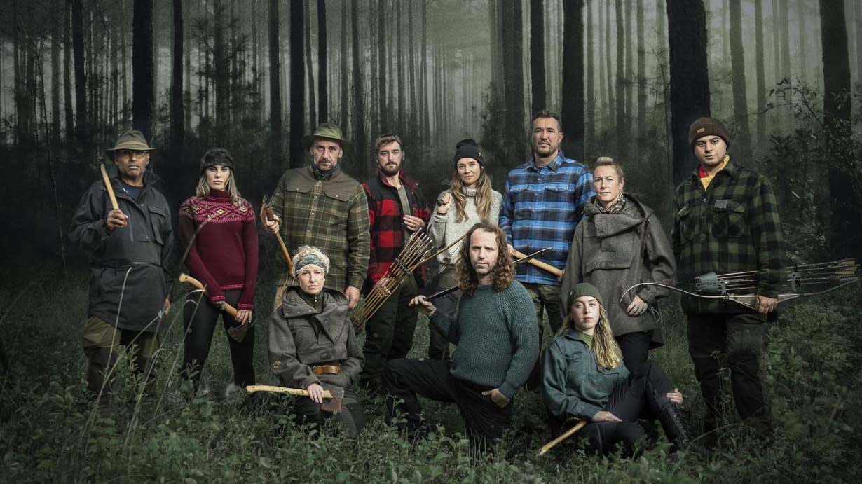  The contestants of Alone UK season 1 assembled in a dark forest.  