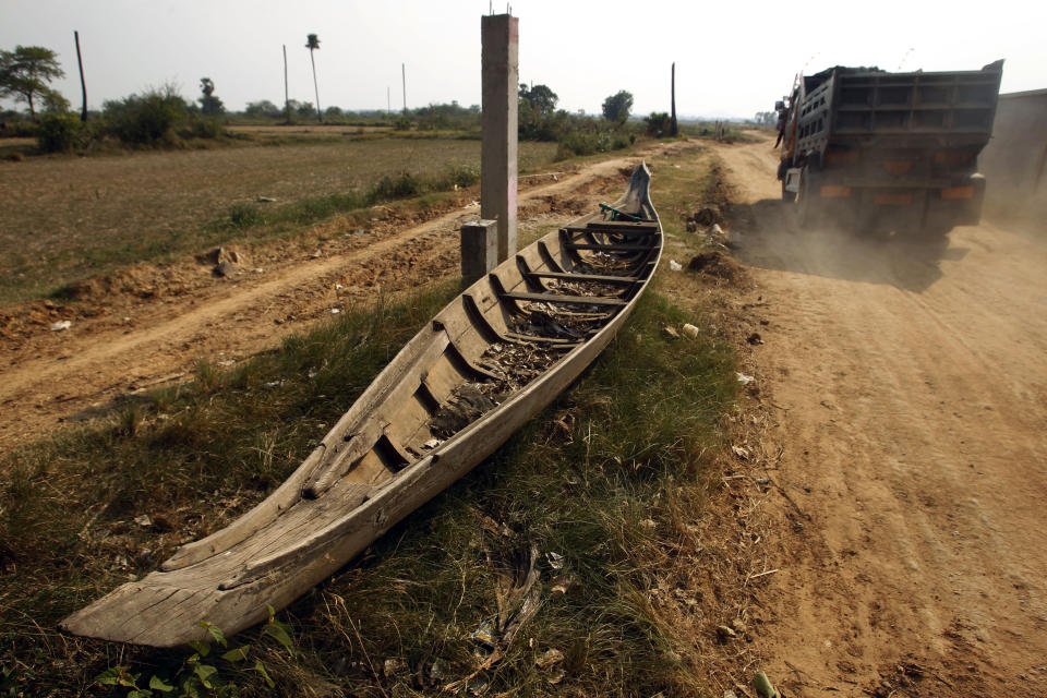 A wooden boat sits on the ground during the dry season outside of Phnom Penh, Cambodia, Thursday, April 25, 2019. Cambodia's government recently issued a statement about a possible two-month drought this year. (AP Photo/Heng Sinith)