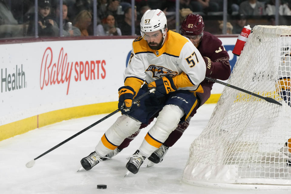 Nashville Predators defenseman Dante Fabbro (57) skates away from Arizona Coyotes left wing Lawson Crouse in the first period during an NHL hockey game, Thursday, March 9, 2023, in Tempe, Ariz. (AP Photo/Rick Scuteri)