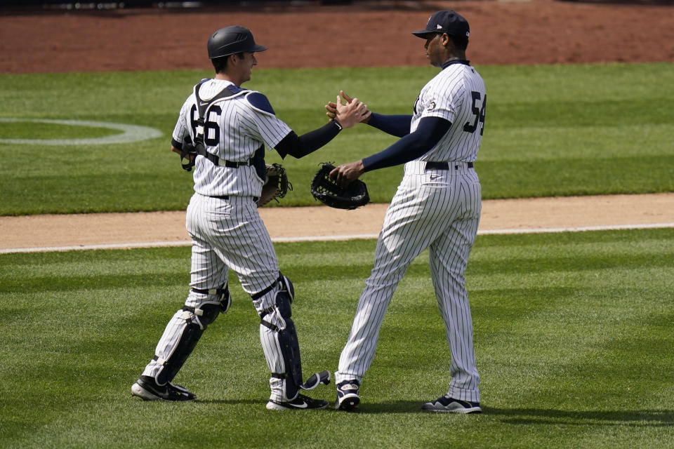 New York Yankees relief pitcher Aroldis Chapman, right, celebrates with catcher Kyle Higashioka after a baseball game against the Detroit Tigers at Yankee Stadium , Sunday, May 2, 2021, in New York. (AP Photo/Seth Wenig)