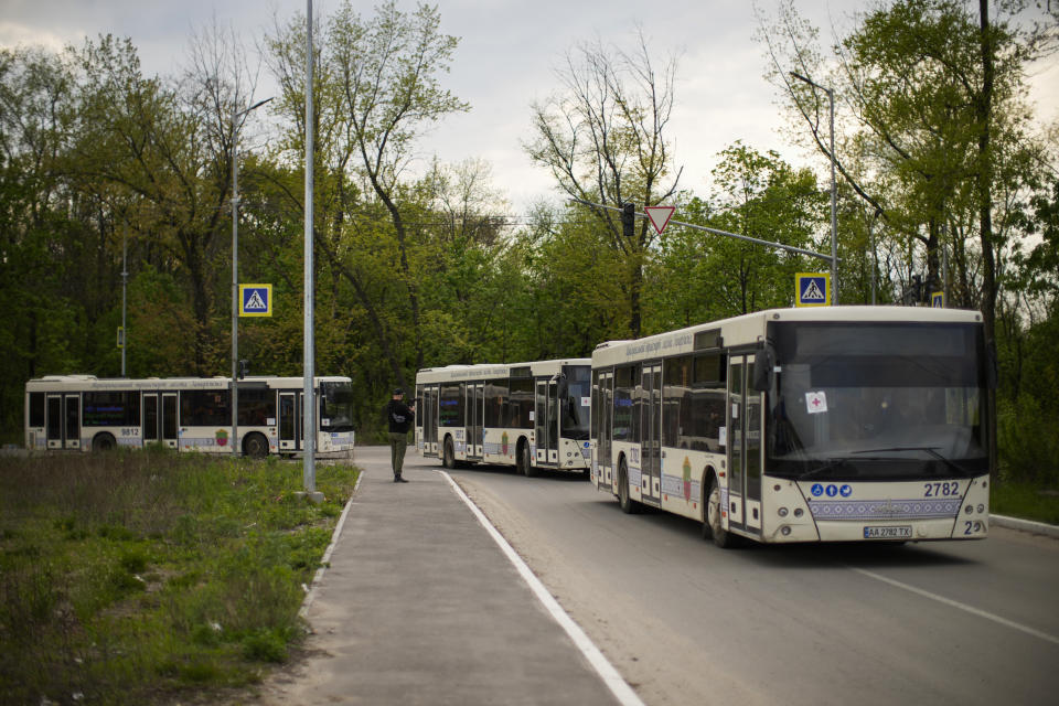 Buses with people who fled from Mariupol and other towns arrive to a reception center for displaced people in Zaporizhzhia, Ukraine, Tuesday, May 3, 2022. Thousands of Ukrainian continue to leave Russian occupied areas. (AP Photo/Francisco Seco)