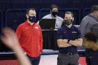 Gonzaga head athletic trainer Josh Therrien, left, and Pepperdine assistant athletic trainer Justin Ericson talk before an NCAA college basketball game in Spokane, Wash., Thursday, Jan. 14, 2021. The pandemic forced trainers to alter the way they do nearly everything. Training rooms were reconfigured with tables spread out for social distancing and limits were put on how many people are allowed in at a time. Masks became mandatory. Cleaning equipment and constant hand washing became a priority. Many schools have gone to appointment-based rehab schedules. (AP Photo/Young Kwak)