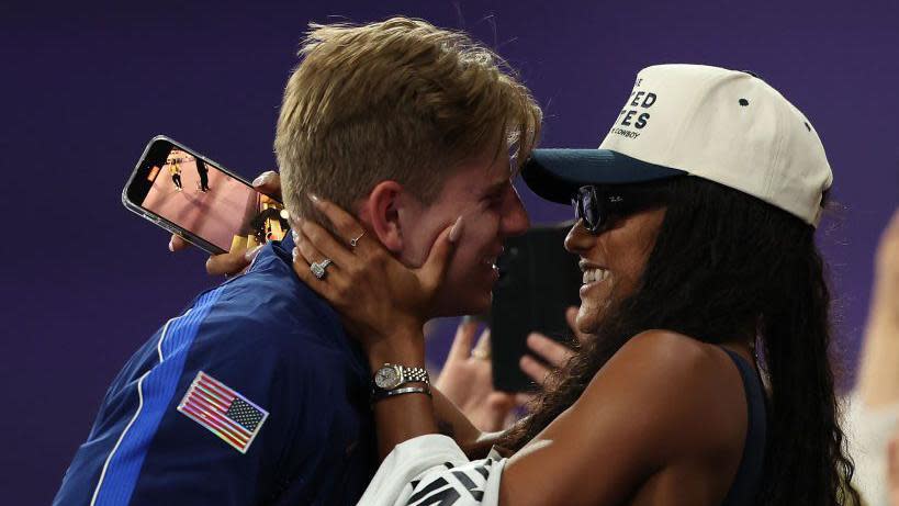 Hunter Woodhall hugging his wife Tara Davis-Woodhall after winning Paralympic gold