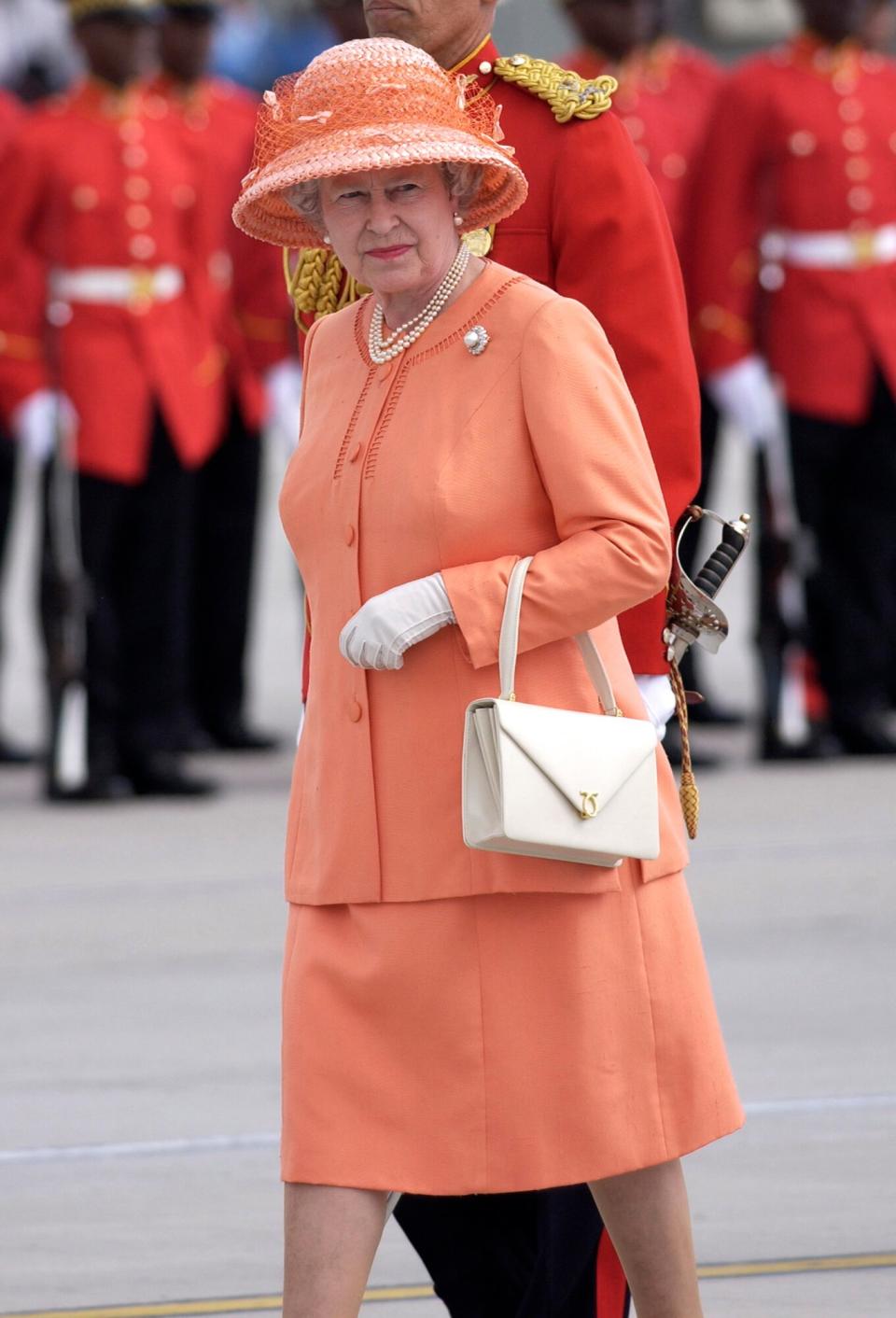 Queen Elizabeth II On Her Jubilee Tour On A Royal Tour To Jamaica Wearing A Suit Designed By Fashion Designer Hardy Amies And A Hat Designed By Milliner Frederick Fox With A Handbag By Launer