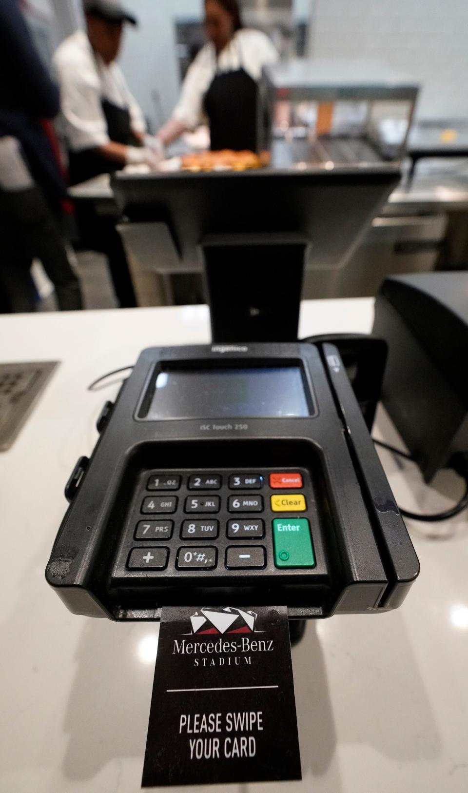 A credit card machine is shown at Mercedes-Benz Stadium during a tour for the NFL Super Bowl 53 football game Tuesday, Jan. 29, 2019, in Atlanta. During its sponsorship renewal with the NFL through the 2025 season, Visa envisions the first cashless Super Bowl. (AP Photo/David J. Phillip)