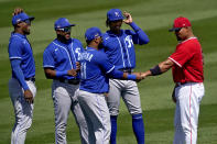 From left; Kansas City Royals' Jorge Soler, Hanser Alberto, Adalberto Mondesi and Carlos Santana (41) smile as they greet Los Angeles Angels' Albert Pujols prior to a spring training baseball game, Wednesday, March 24, 2021, in Tempe, Ariz. (AP Photo/Matt York)