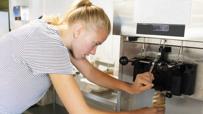girl using silver soft serve ice cream machine