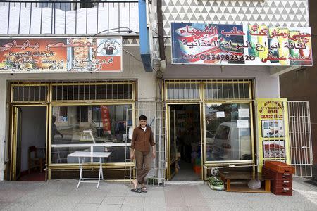 File photo of a Syrian man who had fled the war in his homeland standing outside shops run by Syrians in a low-income neighborhood of Ankara, Turkey, September 29, 2015. REUTERS/Umit Bektas