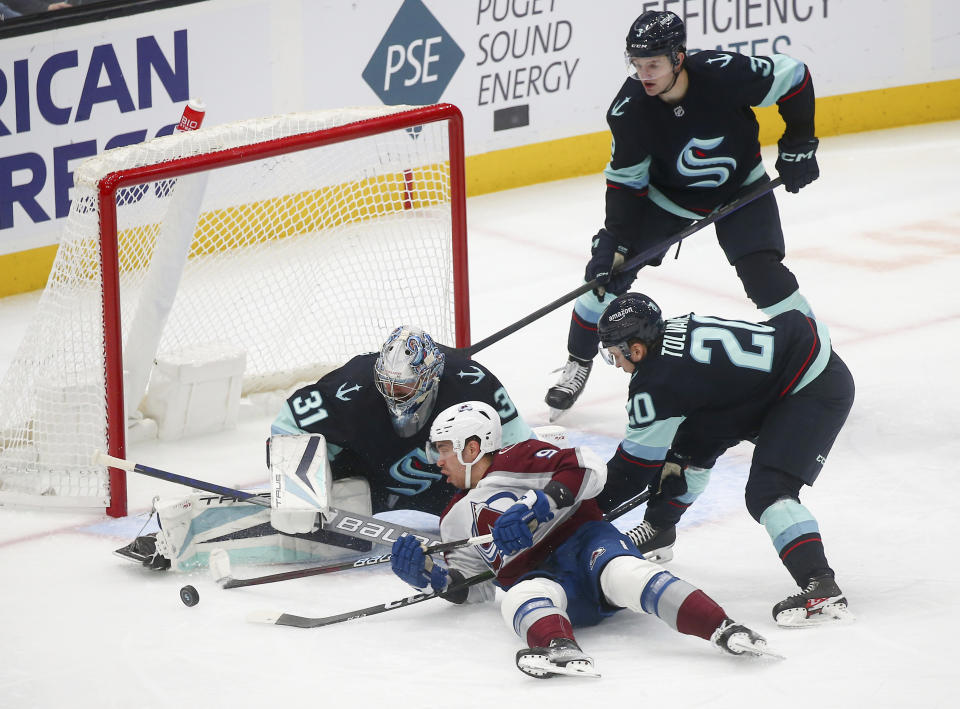 Colorado Avalanche center Evan Rodrigues (9) tries to tap in a goal but Seattle Kraken goaltender Philipp Grubauer (31) makes the block during the first period of an NHL hockey game Saturday, Jan. 21, 2023, in Seattle. (AP Photo/Lindsey Wasson)