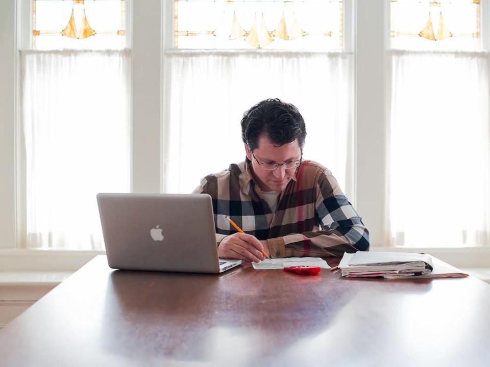 Man Paying Bills with Laptop