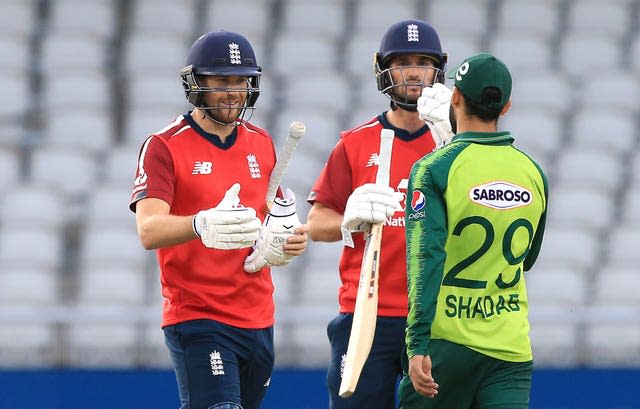 England’s Dawid Malan, left, and Lewis Gregory shake hands with Pakistan’s Shadab Khan after August 2020's T20 win at Old Trafford