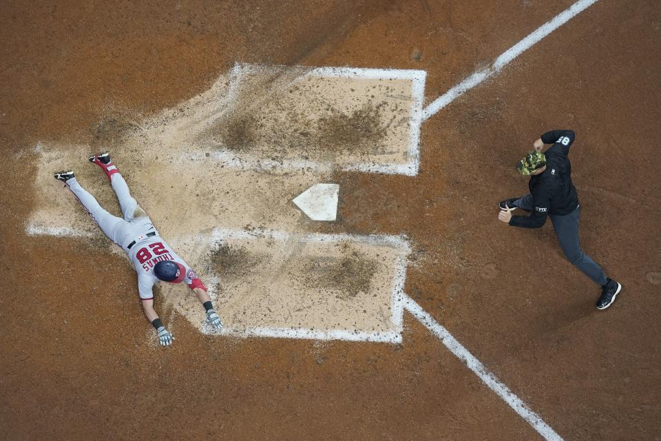 Washington Nationals' Lane Thomas is called out at home during the seventh inning of a baseball game against the Milwaukee Brewers Friday, May 20, 2022, in Milwaukee. Thomas tried to stretch a triple into an inside the park home run. (AP Photo/Morry Gash)