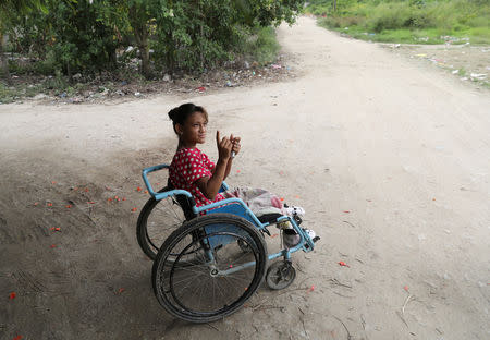 Catherine Ramos, 15, sits in a wheelchair in a street in San Pedro Sula, Honduras, September 20, 2018. REUTERS/Goran Tomasevic