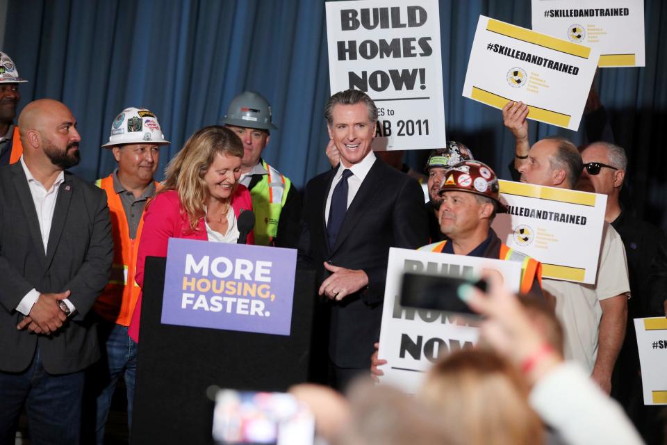 Gov. Gavin Newsom, center, stands with local and state officials at 4200 Geary Blvd., an affordable senior housing development, in San Francisco on Sept. 28. Newsom signed a legislative package to tackle California's housing crisis. The bill accelerates the construction of new housing while also creating thousands of jobs.