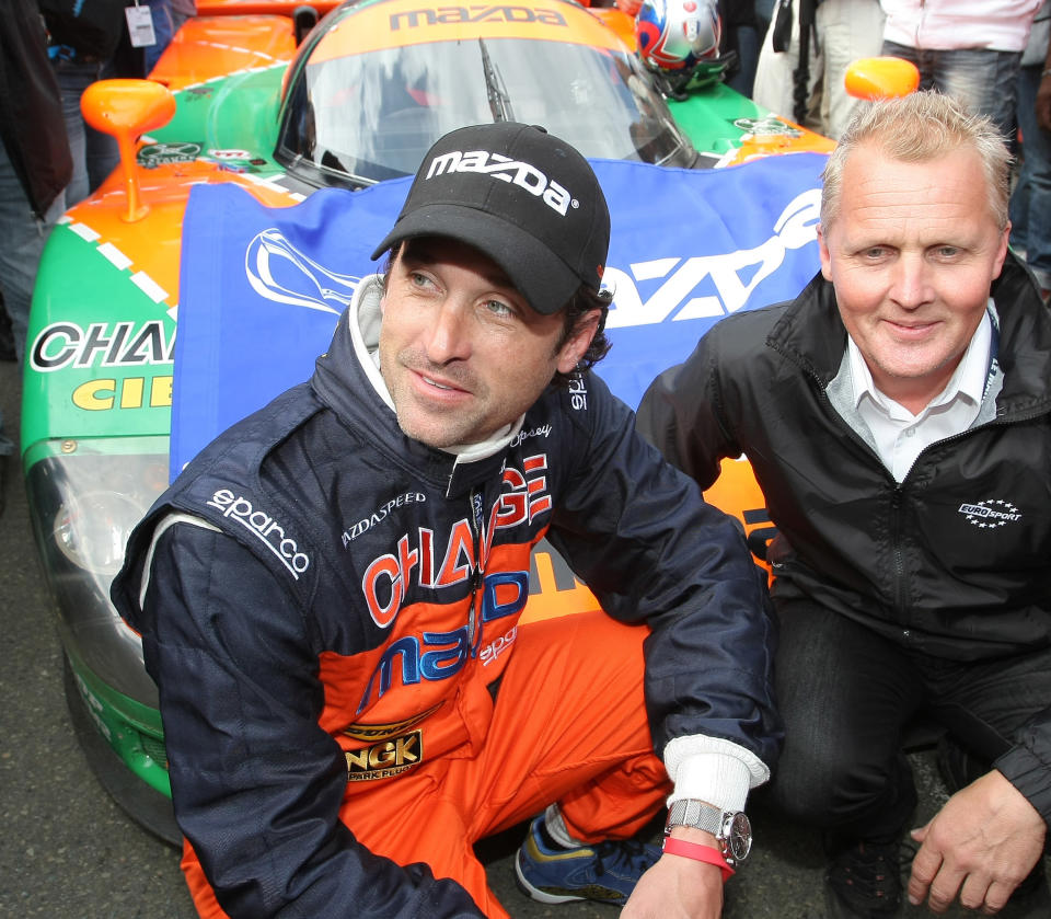 FILE - In this June 9, 2011 file photo, actor Patrick Dempsey, left, and British driver Johnny Herbert pose for photographs in front of the Mazda 787 B, which won the race in 1991, in Le Mans, western France. Dempsey is producing and will be featured in "Road to Le Mans," a Velocity channel series that will follow the actor-race car driver as he prepares for the famed auto endurance race. (AP Photo/Vincent Michel, file)