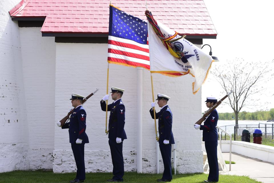 Members of the U.S. Coast Guard stand guard during a presentation of the Purple Heart Medal ceremony at Fort Gratiot Lighthouse in Fort Gratiot, on Monday, May 23, 2022.