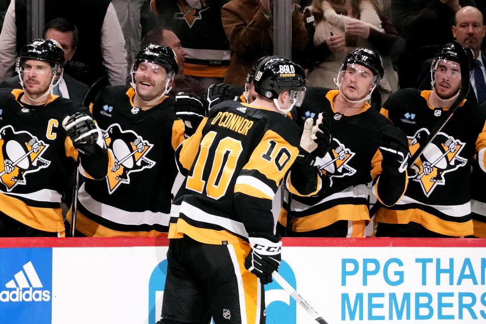 Pittsburgh Penguins' Drew O'Connor (10) returns to the bench after scoring during the second period of an NHL hockey game against the Buffalo Sabres in Pittsburgh, Saturday, Nov. 11, 2023. (AP Photo/Gene J. Puskar)
