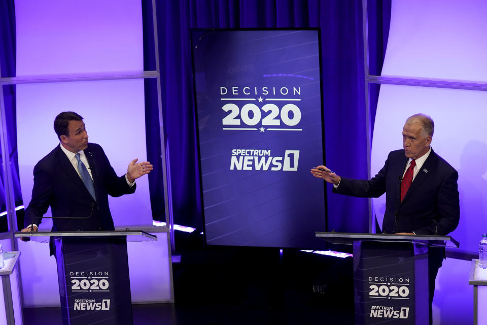 Democratic challenger Cal Cunningham, left, and U.S. Sen. Thom Tillis, R-N.C., talk during a televised debate Thursday, Oct. 1, 2020, in Raleigh, N.C. (AP Photo/Gerry Broome, Pool)