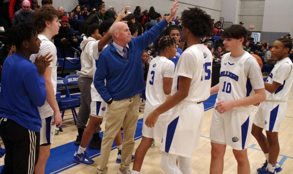 Holbrook head coach Rich Gifford receives his team after a big victory over visiting Falmouth Academy, 70-23, on Monday, Feb. 27, 2023. Holbrook advances to the next round.