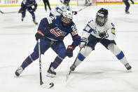 United States forward Kendall Coyne Schofield, left, shields the puck from Finland defensewoman Siiri Yrjola during the second period in the semifinals at the IIHF women's world Hockey Championships in Utica, N.Y., Saturday, April 13, 2024. (AP Photo/Adrian Kraus)