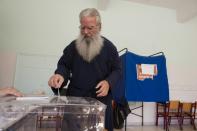 A man casts his referendum ballot in Aegina, Greece