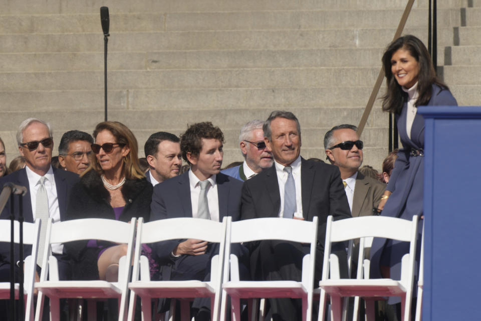 Former South Carolina Gov. Nikki Haley, right, takes her seat next to former Gov. Mark Sanford at the second inaugural of Gov. Henry McMaster on Wednesday, Jan. 11, 2023, in Columbia, S.C. (AP Photo/Meg Kinnard)