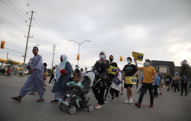 People march the 7km from a crime scene to a mosque in memory of a Muslim family that was killed in what police call a hate-motivated attack in London, Ontario