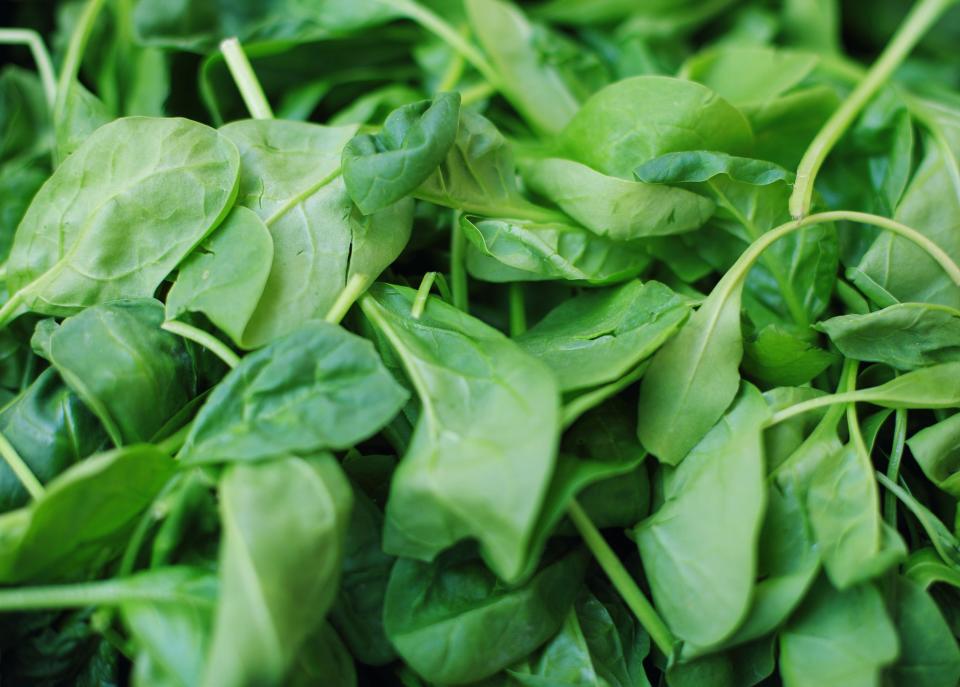 A bunch of bright green, raw spinach.