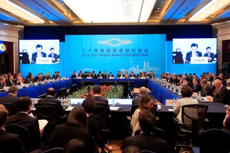 Attendees listen to a speech by China's Commerce Minister Gao Hucheng during the opening ceremony of the 2016 G20 Trade Ministers Meeting in Shanghai, China July 9, 2016. REUTERS/Aly Song