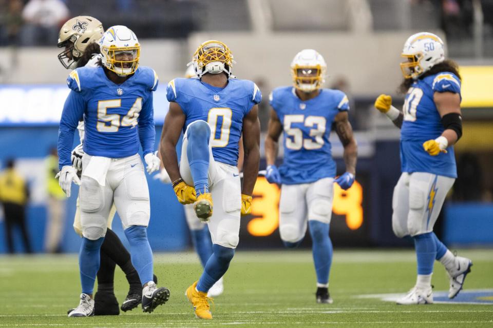 Daiyan Henley celebrates with fellow Chargers.