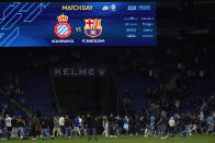 Supporters run in the file after the Spanish La Liga soccer match between Espanyol and Barcelona at the RCDE stadium in Barcelona, Sunday, May 14, 2023. (AP Photo/Joan Monfort)