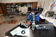 Student Kenny Scottborough, 19, of the Bronx, works on a laptop in a science class at West Brooklyn Community High School, Thursday, Oct. 29, 2020, in New York. The high school is a "transfer school," catering to a students who haven't done well elsewhere, giving them a chance to graduate and succeed. The school reopened Monday after it was forced to shut down for three weeks due to a spike in coronavirus cases in the neighborhood. (AP Photo/Kathy Willens)