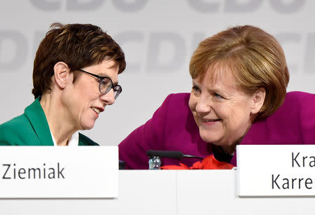 New CDU leader Annegret Kramp-Karrenbauer talks with former CDU chief and German Chancellor Angela Merkel during the Christian Democratic Union (CDU) party congress in Hamburg, Germany, December 8, 2018. REUTERS/Fabian Bimmer