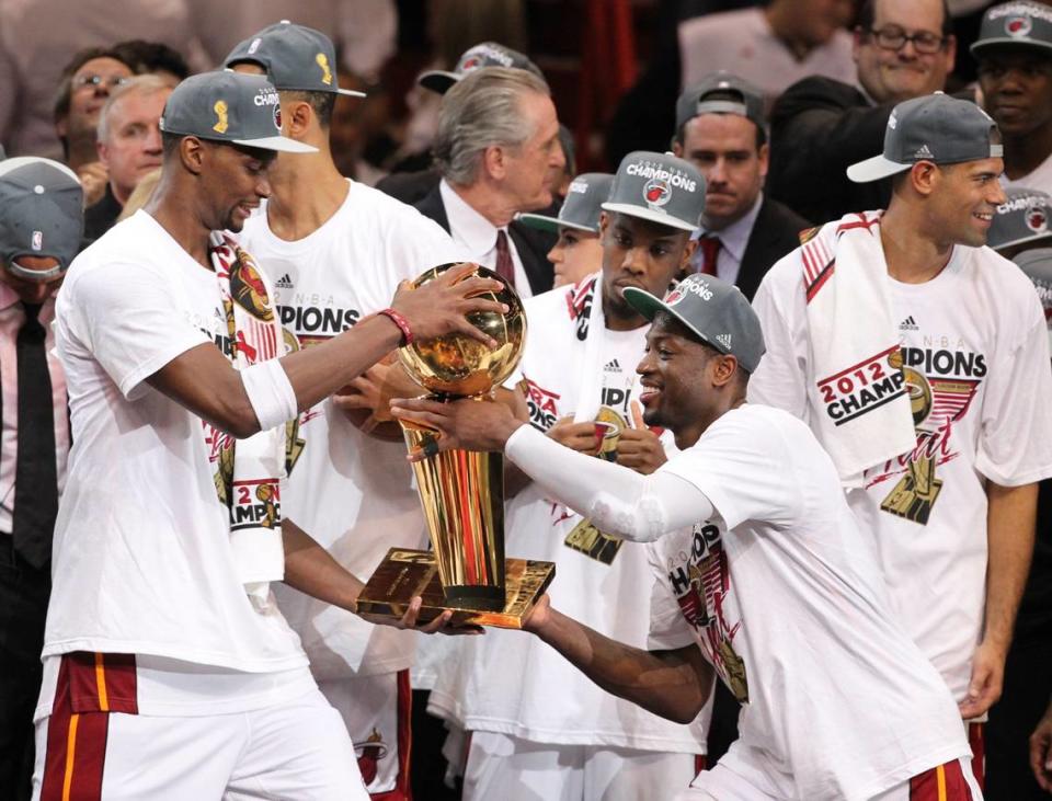 Chris Bosh and Dwyane Wade with the NBA trophy after Game 5 of the NBA Finals between the Miami Heat and the Oklahoma City Thunder at AmericanAirlines Arena on Thursday, June 21, 2012.