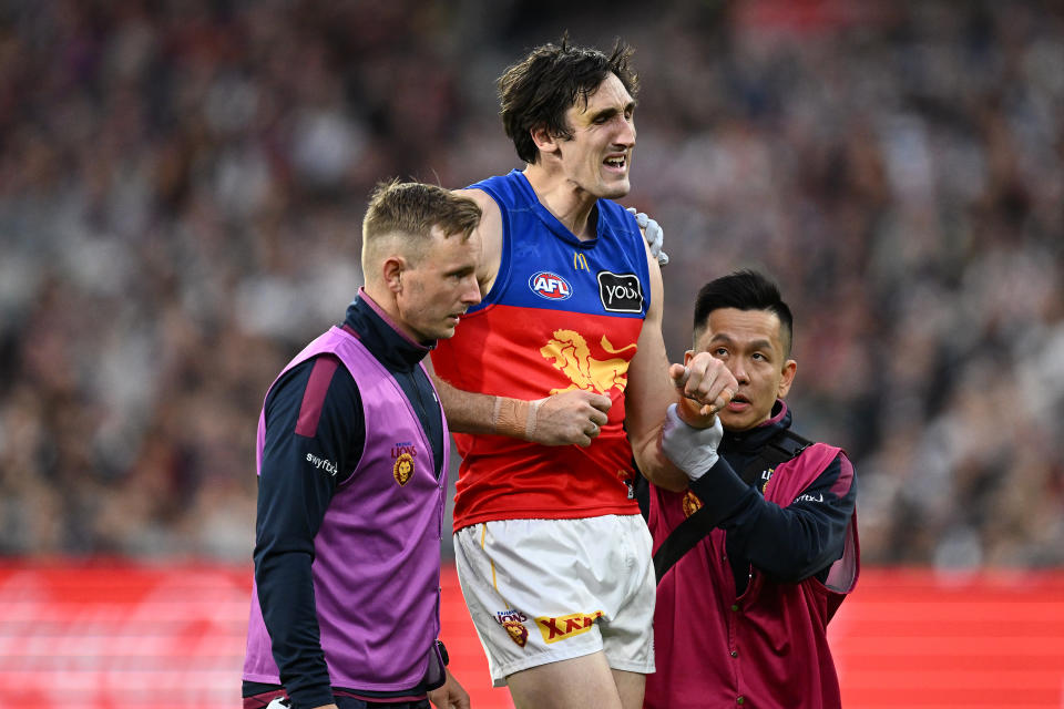 MELBOURNE, AUSTRALIA - SEPTEMBER 21: Oscar McInerney of the Lions receives medical attention after injuring his shoulder during the AFL Preliminary Final match between Geelong Cats and Brisbane Lions at Melbourne Cricket Ground, on September 21, 2024, in Melbourne, Australia. (Photo by Quinn Rooney/Getty Images)